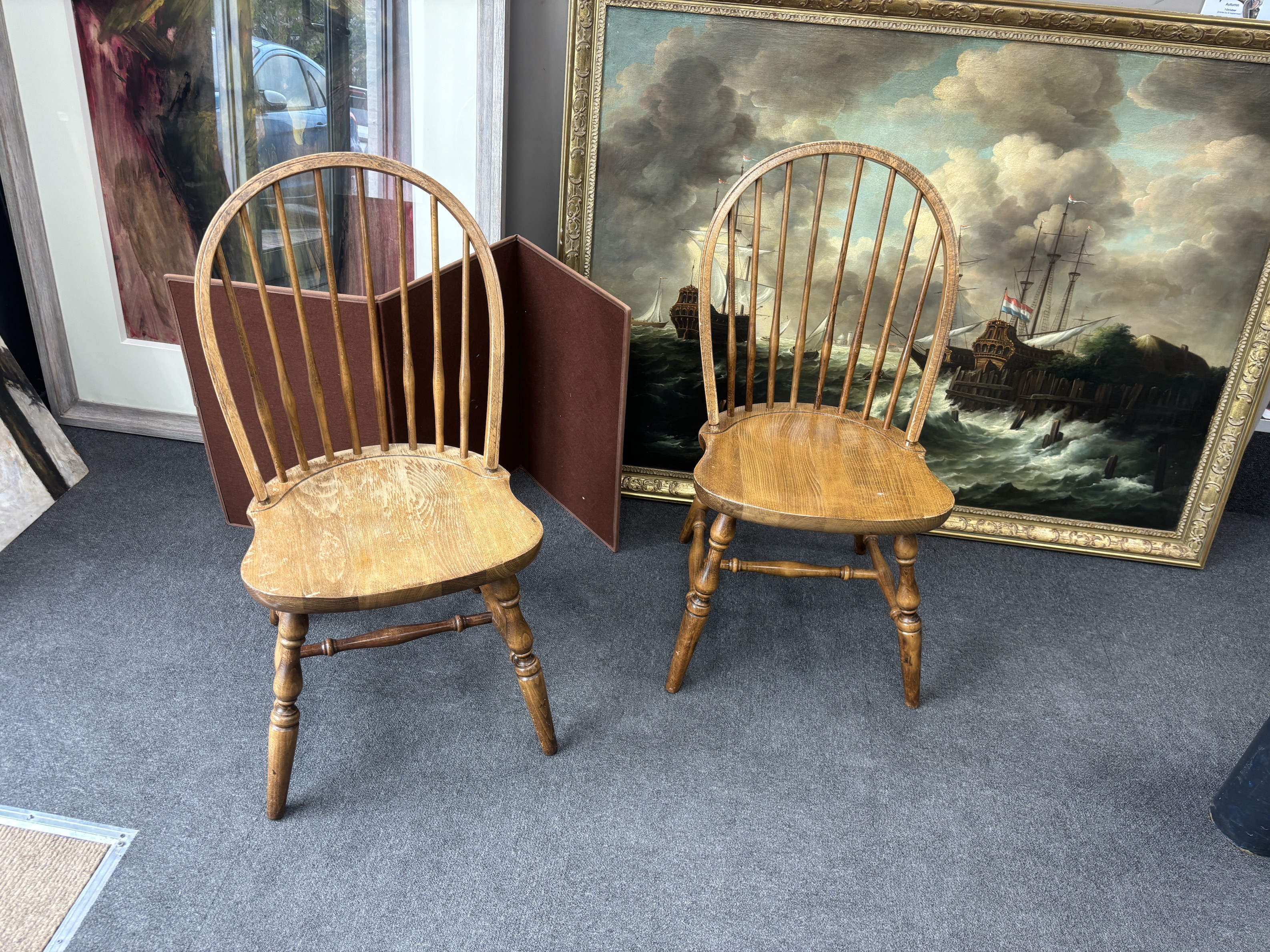 A set of six reproduction Windsor beech comb back dining chairs, two with arms